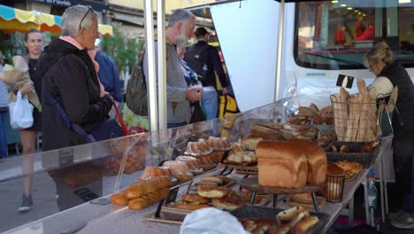 Couple-Buys-Home-Baked-Bread-from-Old-Town-Market-of-Annecy