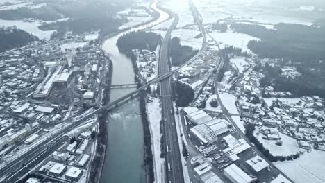 drone-flying-over-highway,-winter,-snowy,-mist,-late-afternoon