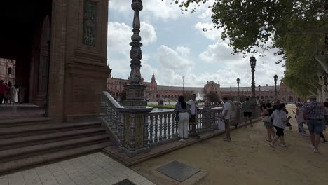 Tourist-admires-Plaza-de-Espana-of-Seville,-motion-view