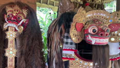 Handheld-shot-of-traditional-scary-masks,-and-Hindu-costumes