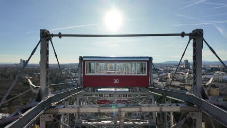 Dolly-shot-moving-through-the-window-of-a-cabin-on-top-of-the-Giant-Wheel-at-Vienna-Prater-Amusement-Park,-Austria---December-2023