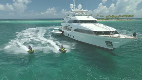 The-jet-skis-revved-their-engines,-circling-around-the-majestic-yacht-anchored-in-the-heart-of-the-sea