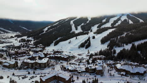 Copper-Mountain-Colorado-ski-resort-foggy-cloud-layer-winter-snowy-early-morning-sunrise-aerial-drone-i70-Eagle-Flyer-lift-center-village-half-pipe-Ikon-pass-snowboard-backward-slowly-pan-up-backwards