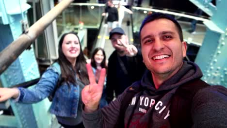 Friends-happily-wave-and-smile-while-ascending-mechanical-stairs