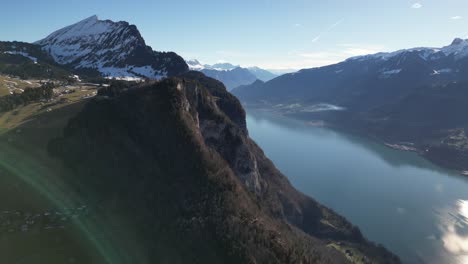 Amden-Weesen-Switzerland-homes-nestled-into-mountain-side-at-sunset-famous-lake