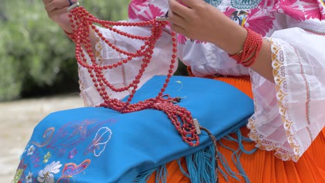 Cinematic-slow-motion-clip-of-a-young-girl-resting-her-beeds-on-the-traditional-oufit-of-Cayambeñas-in-Ecuador