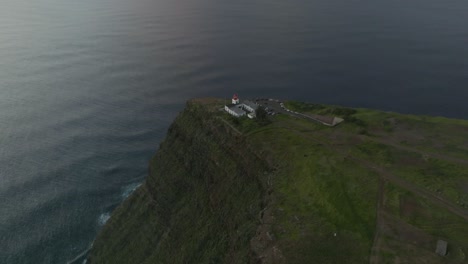 Drone-shot-of-a-lighthouse-on-a-hill-and-view-to-the-sea