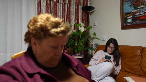 Bored-granny-at-home-being-ignored-by-her-granddaughter-using-the-phone