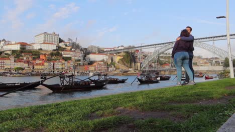 Couple-travel-together,-enjoying-view-of-Porto-and-Douro-River-with-traditional-boats