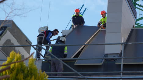 Profesionales-Añadiendo-Paneles-Solares-En-El-Techo-De-Una-Villa-En-Construcción.