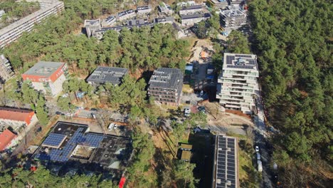 Beautiful-aerial-of-multiple-apartment-buildings-with-photovoltaic-solar-panels-on-the-rooftop