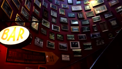 Interior-panning-shot-of-famous-stairs-with-frames-of-Merchants-Arch-pub,-Dublin