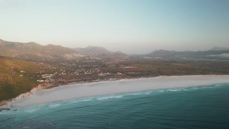 Panoramic-View-Of-Noordhoek-Coastal-Suburb-And-Chapman's-Peak-Drive-In-Cape-Town,-South-Africa---Drone-Shot