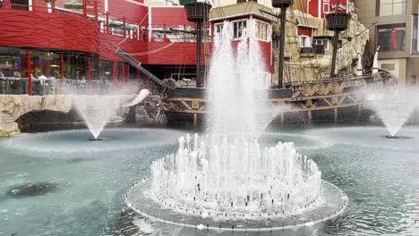 Exterior-shot-of-the-fountains-in-front-of-a-pirate-ship-and-restaurant-at-Treasure-Island-Hotel-and-Casino