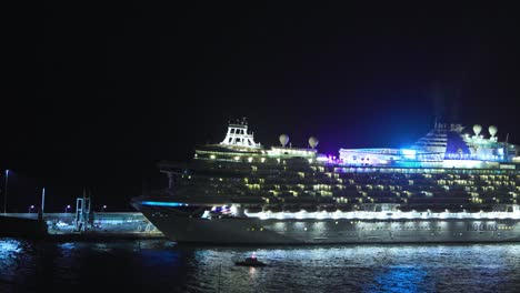 Ocean-liner-AZURA-P+O-Cruise-moored-at-the-Port-of-Funchal-at-night-with-lights-on-reflections