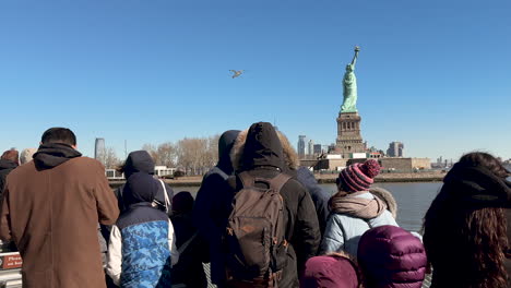 Ferry-with-Tourists-Passes-Near-Statue-of-Liberty-in-New-York-Harbor