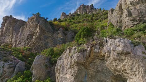 Aerial-ascending-the-Rocky-Mountains-in-Ogden-Utah-Canyon-with-beautiful-foliage-and-blue-sky