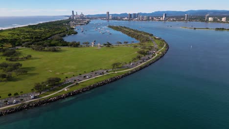 Right-to-left-aerial-views-over-The-Spit-and-the-Broadwater-looking-towards-Surfers-Paradise-on-the-Gold-Coast,-Australia