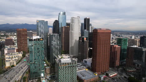 Los-Angeles-CA-USA,-Aerial-View-of-Downtown-Skyscrapers-and-Traffic-on-Harbor-Freeway,-Drone-Shot