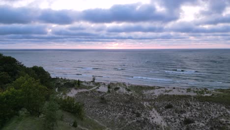 Aerial-Flyover-Dune-Ecosystem-and-Lake-Michigan-Great-lakes-At-sunset