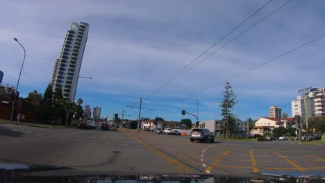 Point-of-view-doing-a-u-turn-over-tram-tracks-and-driving-towards-Surfers-Paradise,-Gold-Coast