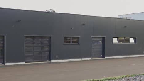 Panning-shot-of-grey-garages-where-car-can-be-maintained-and-serviced