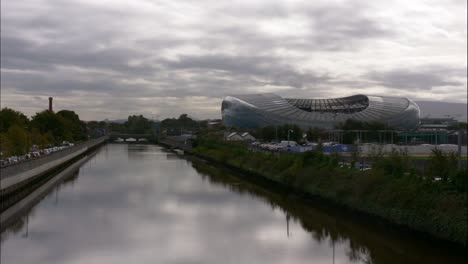 Cloudy-sky-over-Aviva-Stadium-by-the-river,-Dublin,-timelapse