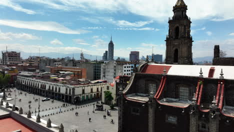 Aerial-view-rising-over-the-Santo-Domingo-Square,-toward-Historic-center-of-Mexico-city