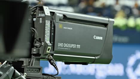 A-Canon-sports-4K-premium-quality-super-zoom-lens-in-operation-during-a-tennis-sporting-event-in-Dubai,-UAE