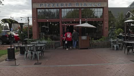 Pizzeria-Bianco-restaurant-outside-with-people-in-front-located-in-Phoenix,-Arizona-with-video-tilting-up