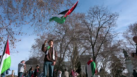 A-young-protestor-waves-a-Palestine-flag-during-a-march-in-solidarity-with-Palestine