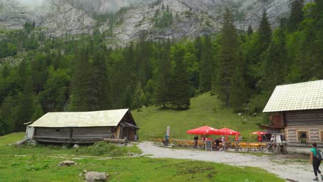 Tourists-Take-a-Rest-in-a-House-in-the-Forest-of-Gosausee