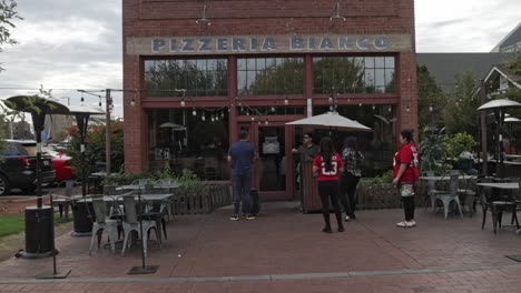 Pizzeria-Bianco-restaurant-outside-with-people-in-front-located-in-Phoenix,-Arizona-with-video-tilting-up