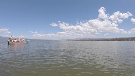 Tourists-with-guide-in-boat-observe-wild-scenery-of-Lake-Naivasha,-Kenya-Africa