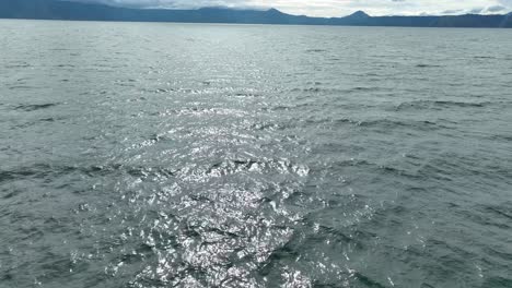 Sunlight-glistening-on-Lake-Toba's-rippling-waters,-speedboat-view