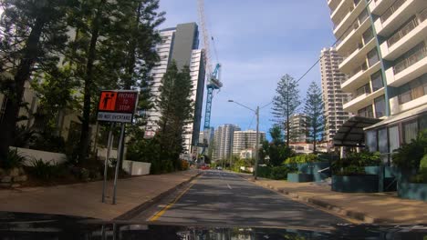 Point-of-view-driving-past-a-construction-site-through-Surfers-Paradise,-Gold-Coast