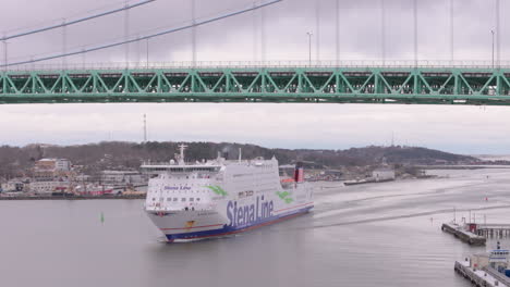 Stena-Line-ferry-approaches-to-cross-under-Älvsborg-bridge,-telephoto-aerial