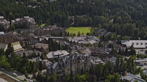 Whistler-BC-Canada-Aerial-v12-zoomed-drone-flyover-resort-town-center,-panning-views-of-thrilling-mountain-bike-park-course,-uphill-lifts-surrounded-by-forests---Shot-with-Mavic-3-Pro-Cine---July-2023