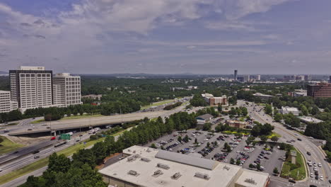 Atlanta-Georgia-Aerial-v997-drone-fly-along-Paces-Ferry-road-capturing-busy-interstate-i-285-highway-traffic-and-the-cityscape-of-the-neighborhood---Shot-with-Mavic-3-Pro-Cine---August-2023