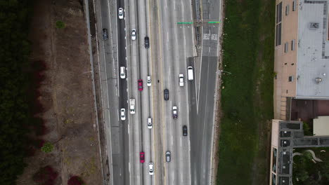 Top-Down-Aerial-View,-Highway-Traffic-in-Downtown-Los-Angeles-USA-Area,-US-101-Route-and-North-Hill-Street-Bridge,-High-Angle-Drone-Shot