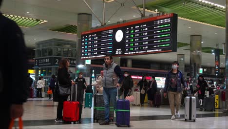 Travellers-with-luggages-seamlessly-navigate-through-Taoyuan-High-Speed-Rail-Station's-arrival-and-departure-hall,-connecting-effortlessly-to-airport-networks,-capturing-the-essence-of-Taiwan-tourism