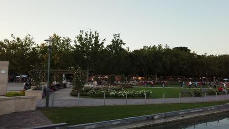 Organized-and-clean-flowery-park-with-walking-people-in-summer-from-Balatonfüred,-Hungary