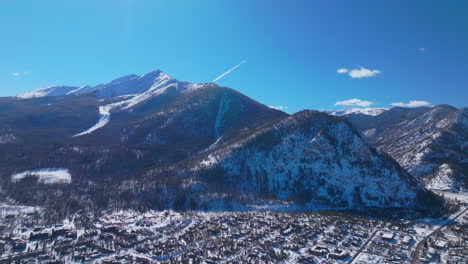 Winter-bluebird-sky-daytime-snowy-downtown-Frisco-aerial-drone-ten-mile-range-main-street-Colorado-mountain-ski-town-Copper-Ikon-Pass-Breckenridge-Silverthorne-Dillon-Summit-County-downward-motion