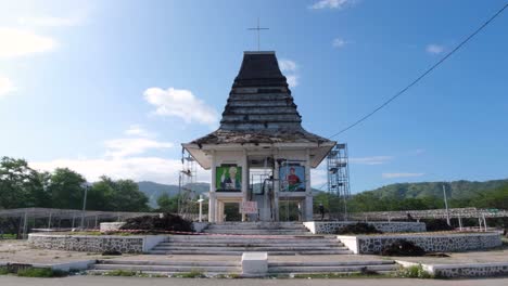 View-of-traditional-Timorese-house-replica-under-renovation-within-Peace-Park-in-Tasitolu-area-of-capital-city-of-East-Timor,-Southeast-Asia