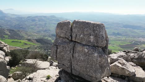 Aerial-drone-footage-captures-the-stunning-landscape-of-Torcal-de-Antequera,-focusing-on-the-unique-rock-formation-known-as-"El-Casco