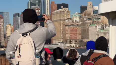 Man-Takes-Photo-of-Downtown-Manhattan-Skyline-from-Ferry