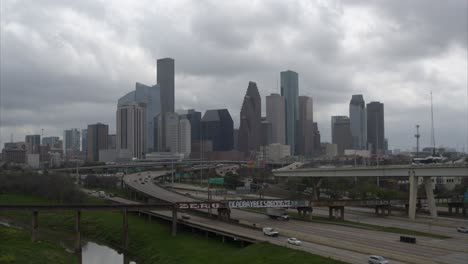 Ascending-drone-shot-of-downtown-Houston,-Texas-on-a-cloudy-day