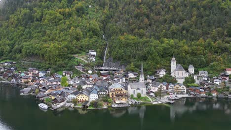 Hallstatt-Village-and-Halstattersee-in-Austria-Alps---Aerial-4k-Backwards