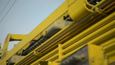 Close-up-of-yellow-machinery-details,-with-selective-focus-and-blurred-background