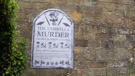 The-Umbrella-Killer,-Victim-Georgi-Markov-Board-in-The-Poison-Garden,-Alnwick,-England-UK